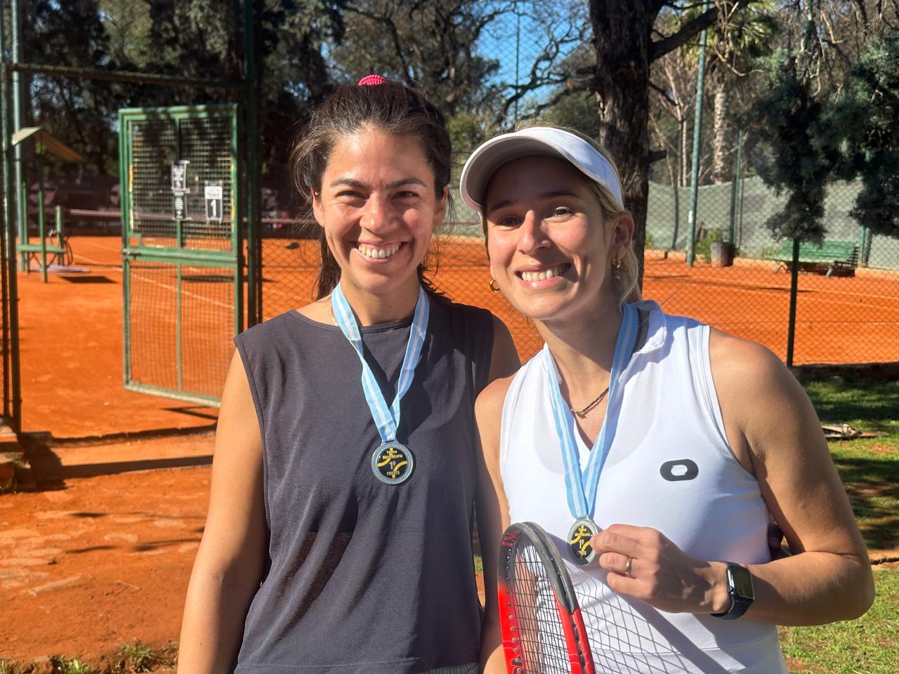 Dos alumnas festejando con medallas después de un torneo